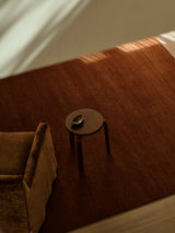 Armadillo Thatch Rug in Copper, hand-knotted wool rug shown in a room setting