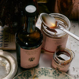 Chef's Kiss Gift Set — olive oil bottle, honey jar, and Guajillo Salsa Macha on wood surface
