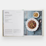 Calimia Home The Regional Italian Cookbook book open to a spread showing a lentil and tomato soup recipe.