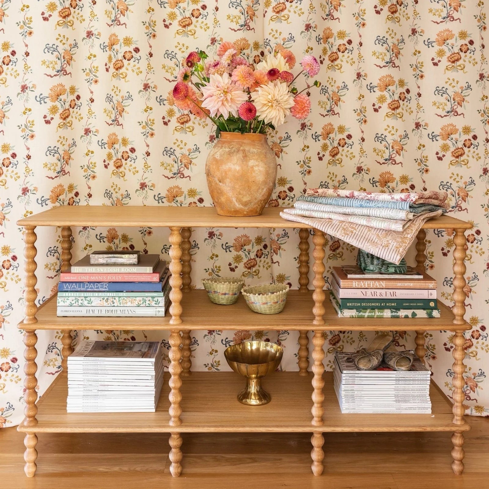Calimia Home three tier natural oak console table with hand-turned bobbin posts and decorative shelf styling