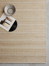 Armadillo Trellis Rug in Natural & Sandstone, a second view of the handwoven wool and jute rug in a styled interior