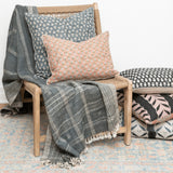 Calimia Home Tulsi teal floral hand-block-printed linen pillow with feather insert on a wooden chair with a throw
