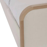 Calimia Home Vance Bed featuring a curved upholstered headboard in Belgian linen with a solid oak wood trim frame.