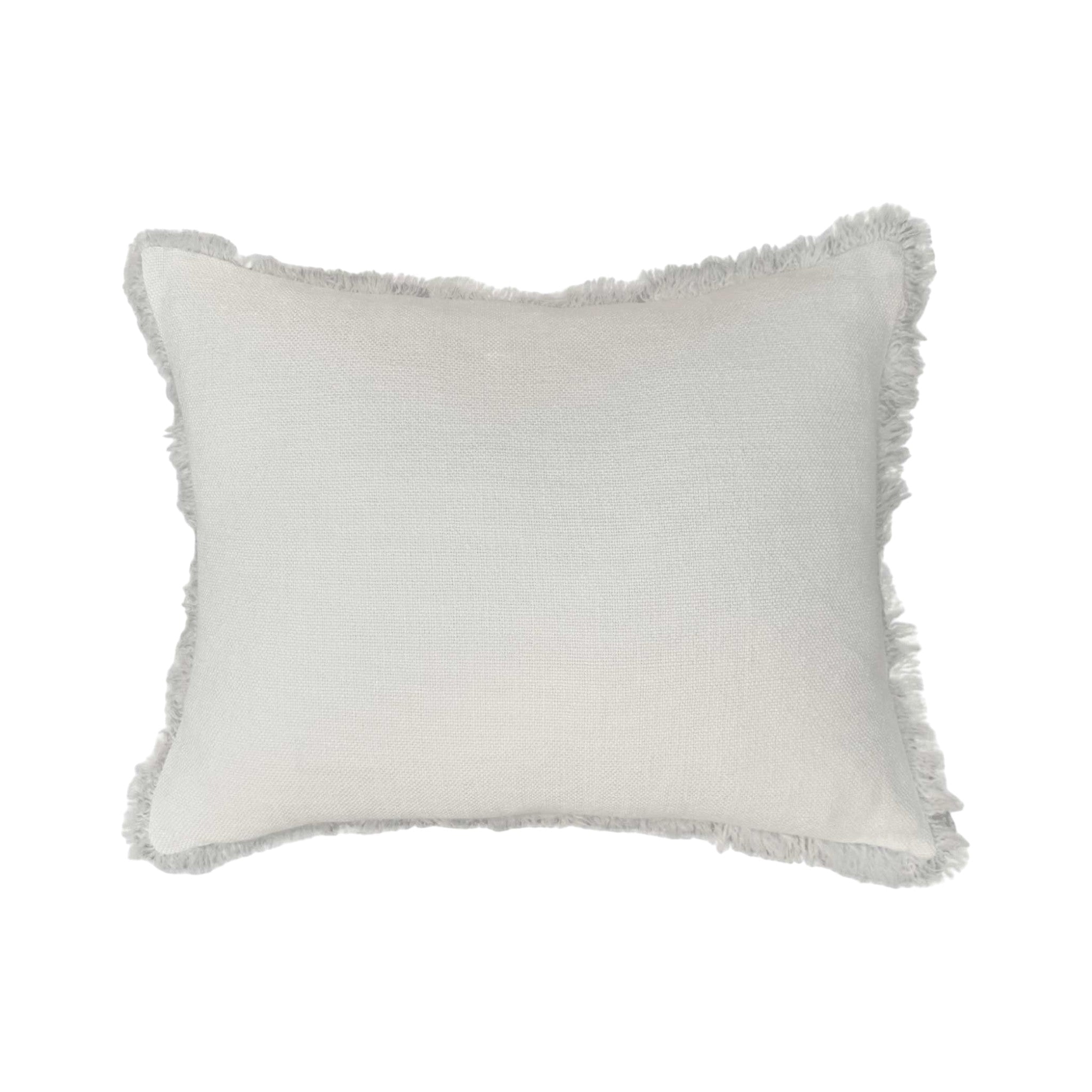 One Bi One white Belgian linen Vera pillow with delicate fringe trim and a clean hidden zipper closure.