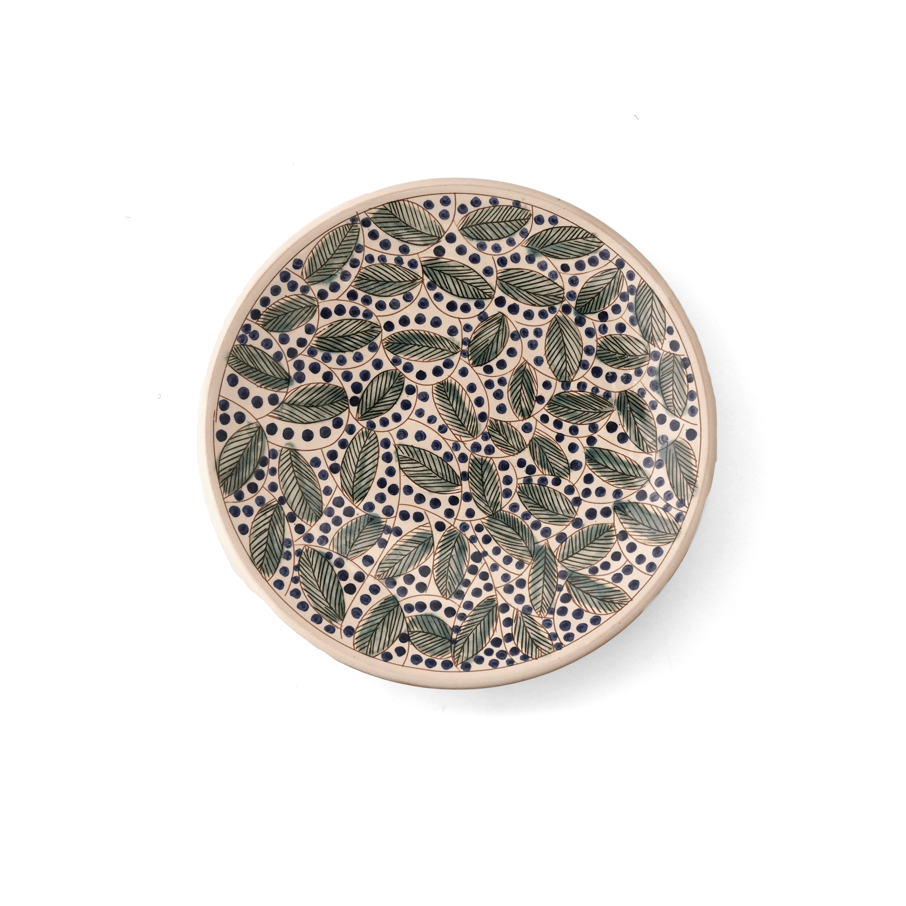 Round ceramic plate with leaf pattern on a white background 