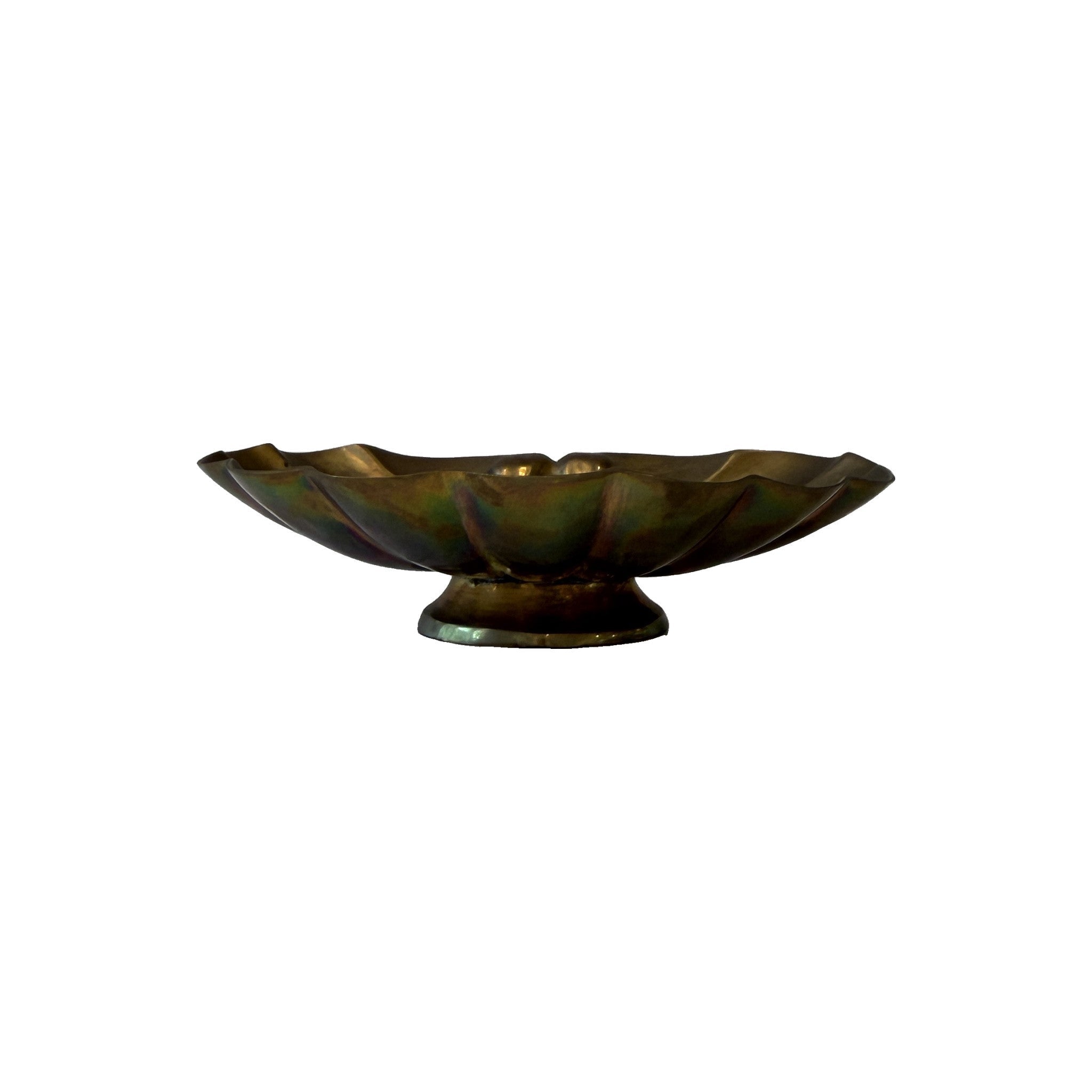 Vintage brass scallop shell dish in profile on its turned pedestal foot, showing iridescent green and rose patina across the lobes