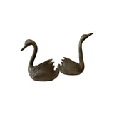 Mirrored pair of vintage brass swan jardinieres facing one another, necks drawn up in long S curves with raised wings