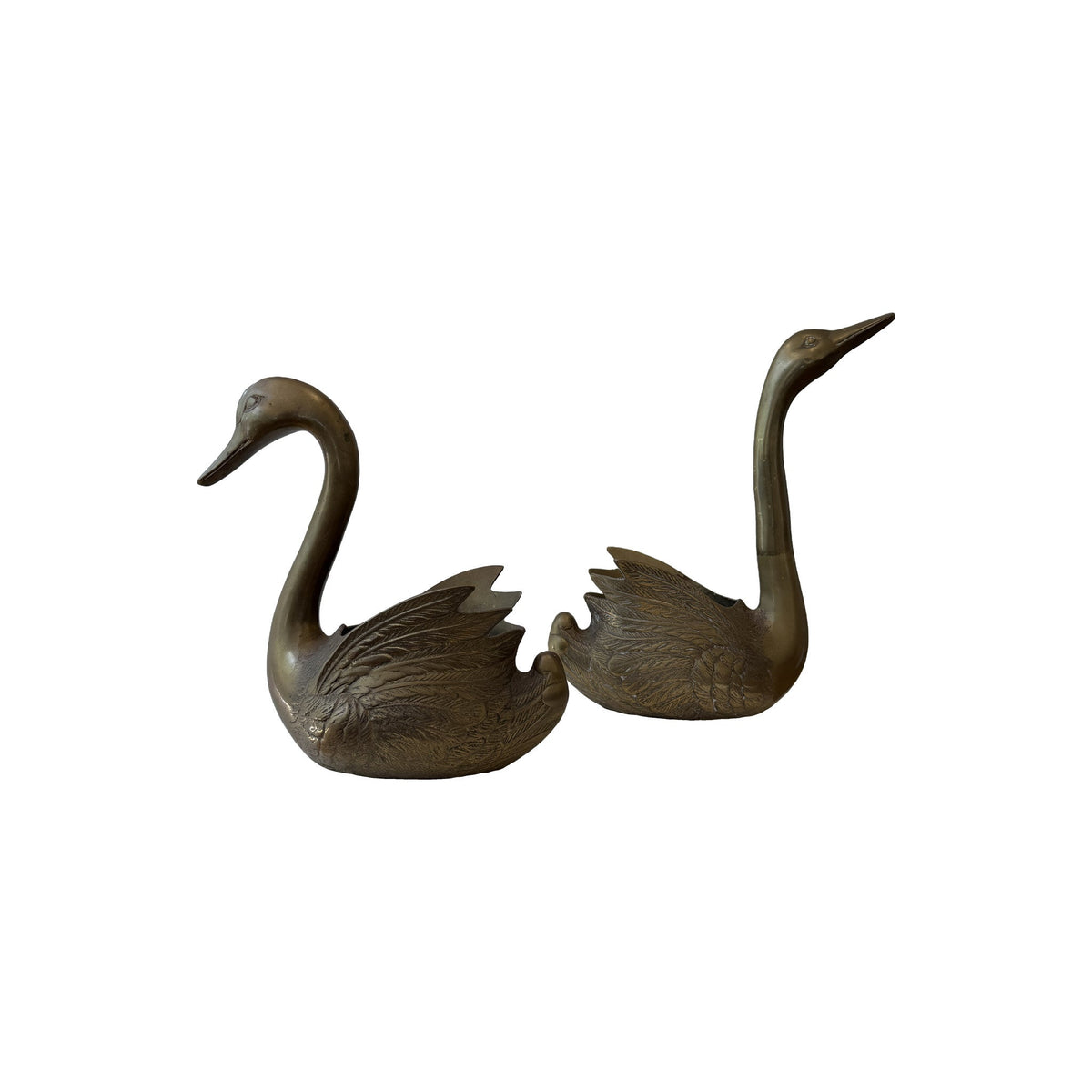 Mirrored pair of vintage brass swan jardinieres facing one another, necks drawn up in long S curves with raised wings