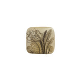 Vintage ceramic botanical wall tile with a broad fern frond, dock leaves and ribboning grasses pressed into speckled cream stoneware