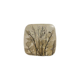 Vintage ceramic botanical wall tile with fine meadow grasses in seed and a fern frond pressed into speckled cream stoneware, the largest of three