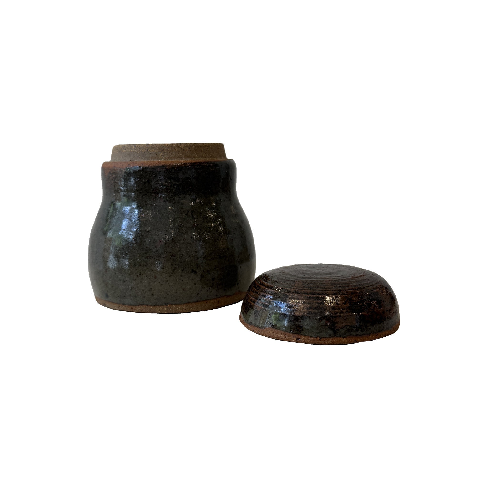 Faye 1983 stoneware jar with the lid lifted off, showing the unglazed rim and the waisted body profile
