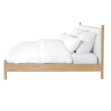 Calimia Home Wilfred Bed featuring a natural oak frame, low footboard, and white upholstered headboard side view.