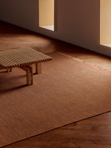 Armadillo Willow Rug in Henna, handwoven flatweave rug shown in a room setting