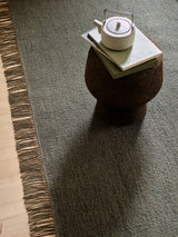 Armadillo Willow Rug in Cypress, a second view of the handwoven flatweave rug in a styled interior