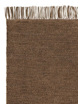Armadillo Willow Rug in Cumin, corner close-up of the linen, wool, and jute pile and edge