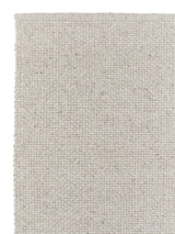 Armadillo Winnow Rug in Alabaster, corner close-up of the wool pile and edge