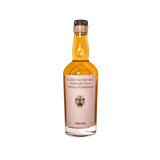 A clear Flamingo Estate Winter Harvest Persimmon Vinegar bottle of amber liquid, Ambrosia Fuyu Hachiya, with a cork-style cap on white.