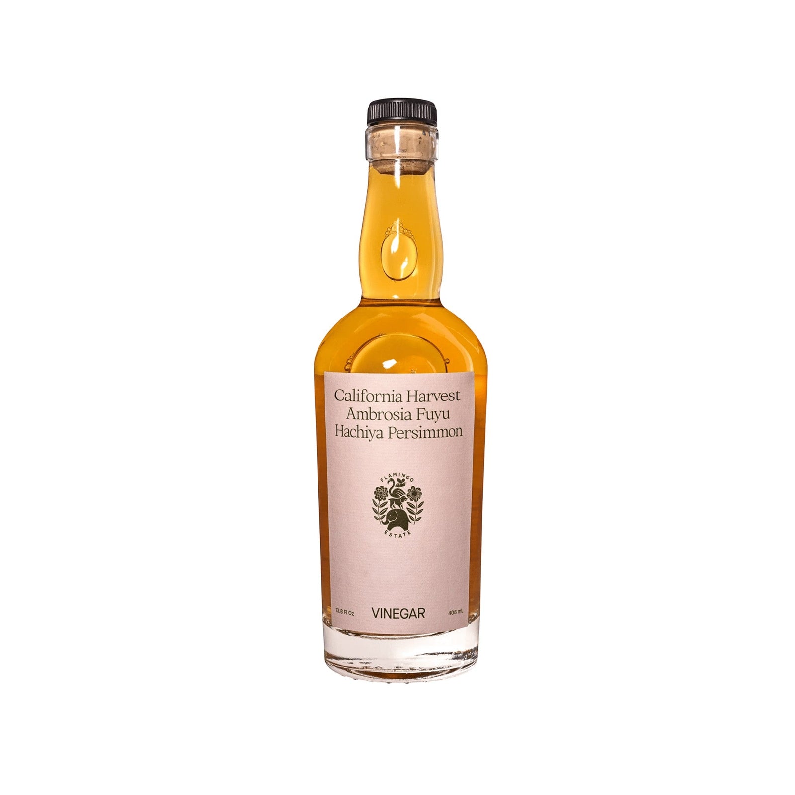 A clear Flamingo Estate Winter Harvest Persimmon Vinegar bottle of amber liquid, Ambrosia Fuyu Hachiya, with a cork-style cap on white.