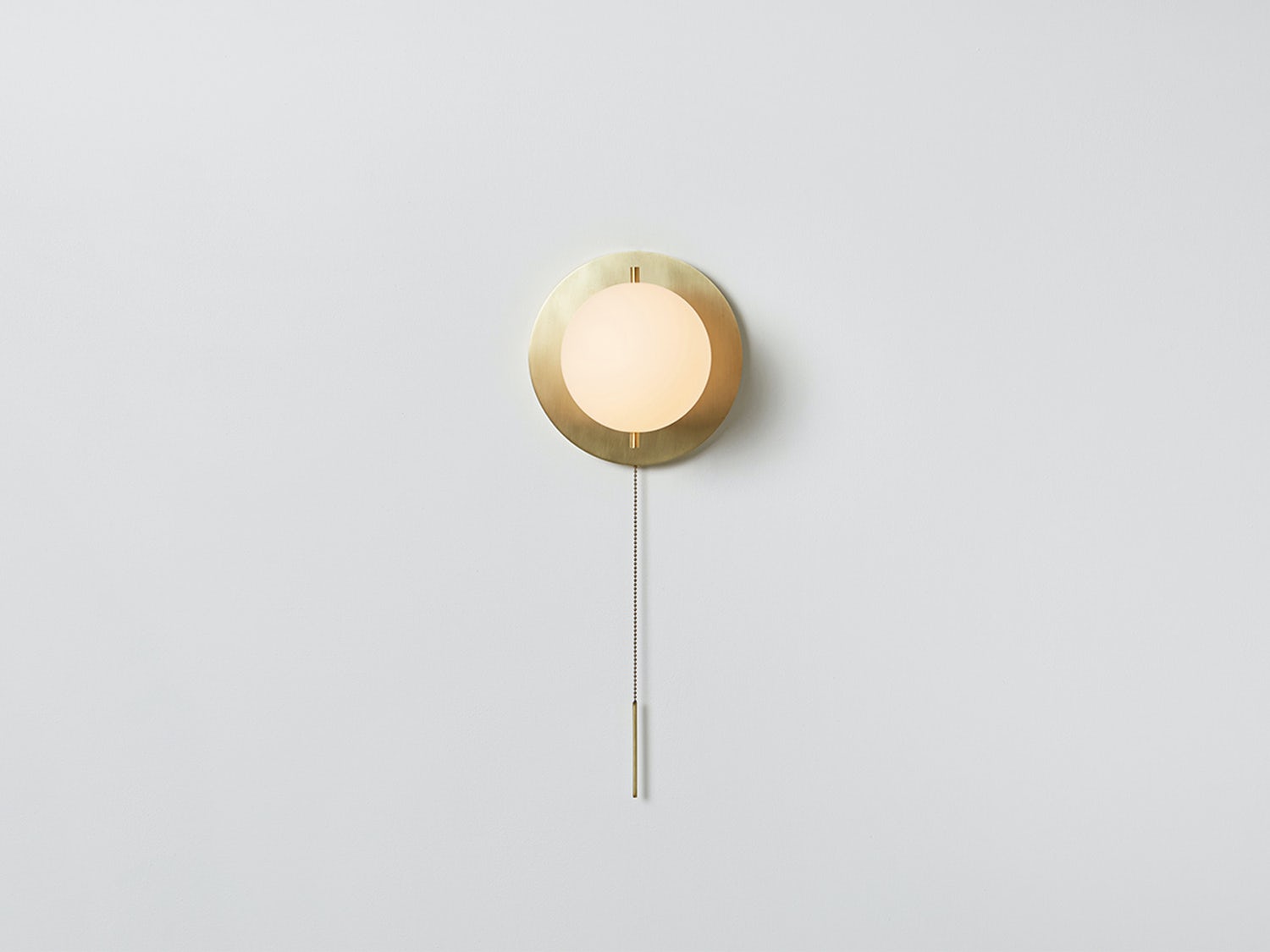 Workstead Signal Sconce in Hewn Brass, illuminated