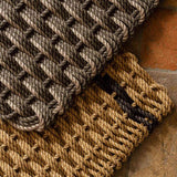 Woven doormat in mushroom and sand — texture detail